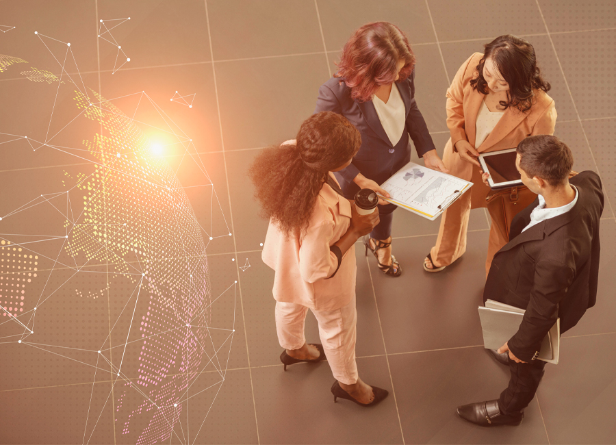 International business team discussing market expansion strategies with documents and digital devices, symbolizing global trade and collaboration.