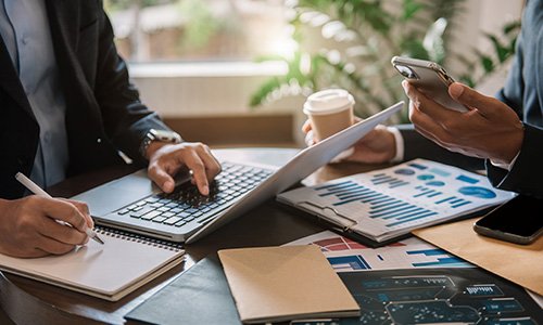 Business professionals reviewing corporate income tax reports and financial data in Germany